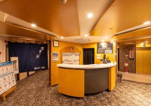 a lobby with a yellow and white counter in a room at APA Hotel Kanazawa Ekimae in Kanazawa