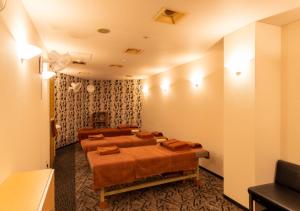 a room with a group of beds in it at APA Hotel Kanazawa Ekimae in Kanazawa
