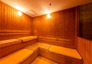 a sauna with two benches in a wooden room at APA Hotel Kanazawa Ekimae in Kanazawa
