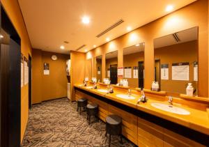 a public bathroom with two sinks and two mirrors at APA Hotel Kanazawa Ekimae in Kanazawa
