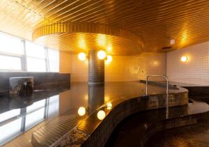 a bathroom with a tub and a sink in a room at APA Hotel Kanazawa Ekimae in Kanazawa +37 photos