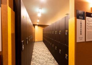 a hallway with alot of lockers in a building at APA Hotel Kanazawa Ekimae in Kanazawa