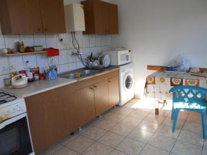 a kitchen with a sink and a washing machine at Residence Krstanoski in Ohrid