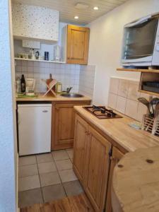 a kitchen with a sink and a stove top oven at Le Français, studio au calme proche de la gare in Besançon