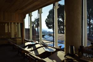 a porch with chairs and a view of a building at Cella Grande in Viverone