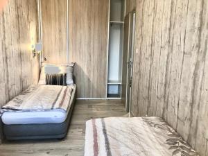 a small room with a bed and a closet at Part Royal Apartments in Keszthely