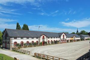 a large white building with a fence around it at Lamballe plein centre, superbe appartement 1er étage in Lamballe