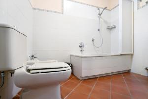 a white bathroom with a toilet and a shower at Casa Conte Picedi appartamento Luna in Lerici +15 photos