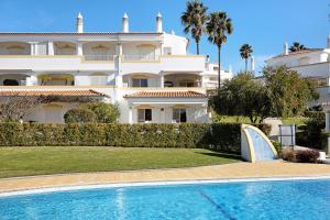 a large building with a swimming pool in front of a house at Casa Primavera in Carvoeiro