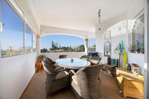 a room with a table and chairs and a balcony at Casa Primavera in Carvoeiro