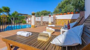 a deck with a table and chairs and a pool at Cortijo El Olivar Órgiva by Ruralidays in Órgiva