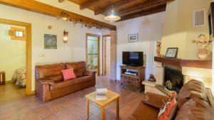 a living room with a couch and a fireplace at Cortijo El Olivar Órgiva by Ruralidays in Órgiva