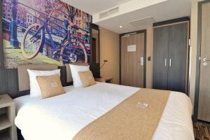 Postel nebo postele na pokoji v ubytování XO Hotel Inner