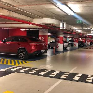 a parking garage with a red car parked in it at Maison Royale in Belgrade