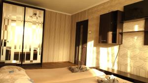 a bedroom with a bed and a large window at Проспект Незалежності 48 City Rooms in Bila Tserkva