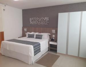 Cama ou camas em um quarto em Allia Gran Pampulha Suites