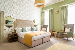 a bedroom with a large bed and a chair at The Queensberry Hotel in Bath