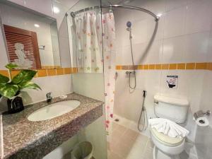 a bathroom with a toilet and a sink and a shower at PJ Patong Resortel in Patong Beach