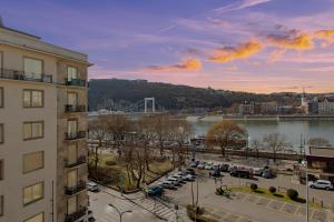 a building with a view of a river and a bridge at Jackquaters in Budapest