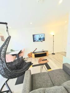 a living room with a couch and a chair with an umbrella at Lovely Studio Serviced Apartment Sheffield City Centre - Netflix, WiFi, Digital TV in Sheffield
