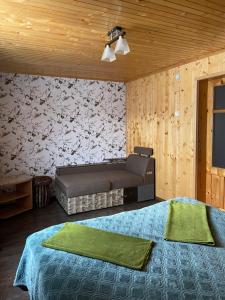 a bedroom with two beds with green sheets at Роздоріжжя in Yaremche