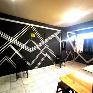 a dining room with a black and white wall at Cabanatuan City PNY Transient INN 2 in Cabanatuan