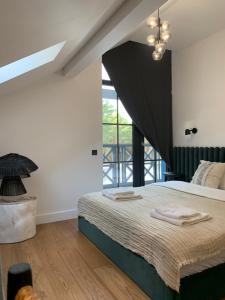 a bedroom with a bed and a large window at Sangrita Nida ADULTS ONLY in Nida