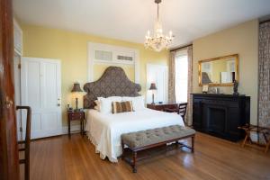 a bedroom with a large bed and a chandelier at Kehoe House, Historic Inns of Savannah Collection in Savannah