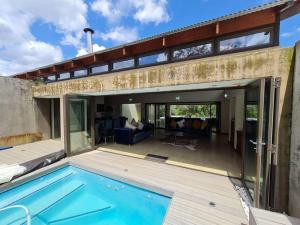 a house with a swimming pool and a patio at No 16 Elements - 5 Bedroom Beauty in Moheme