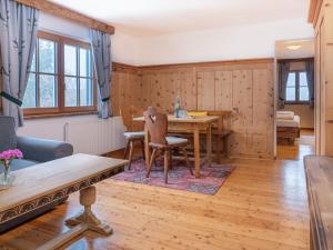 a dining room with a table and a couch at Landgasthof & Restaurant Batzenhäusl in Sankt Gilgen +81 photos