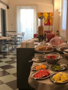 a buffet with many plates of food on a table at Hotel Tirrenia in Viareggio