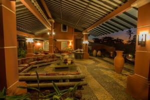 a house with a patio with a couch and a table at Aimberê Eco Resort Hotel in Coqueiro