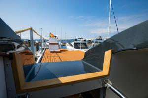 a seat on the deck of a boat at NAVIS SIREN Barco Apartamento in Baiona