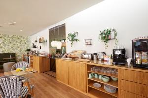 a coffee shop with a counter with a coffee maker at Sintra Green Chalet Bed & Breakfast in Sintra