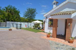 a house with a patio and a swimming pool at El Moral in Cádiz