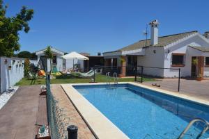 a swimming pool in front of a house at El Moral in Cádiz