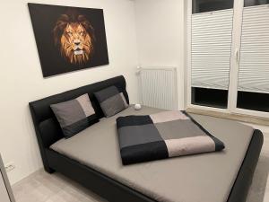 a bedroom with a bed with a lion picture on the wall at Stunning 3-Room Penthouse Lakeview with Terrace in Bucharest
