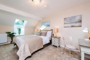 a bedroom with a bed and a desk and two windows at MOUNT BARKER in Swords