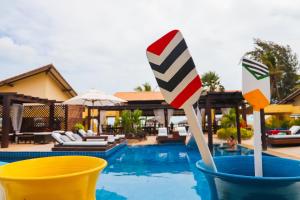 a resort with a pool with twoanas in a bucket at Aimberê Eco Resort Hotel in Coqueiro