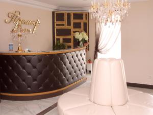 a luxury salon with a white table and a chandelier at Premier Hotel in Gorodets