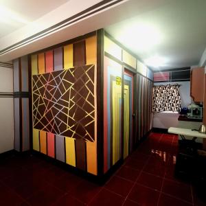 a room with a colorful wall with doors at Cabanatuan City PNY TRANSIENT INN 3 in Cabanatuan