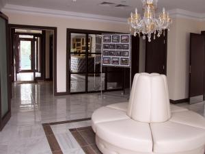 a white chair in a room with a chandelier at Premier Hotel in Gorodets