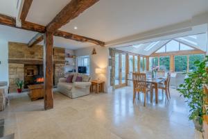 a conservatory living room with a table and chairs at Crofter's Barn in Chipping Norton