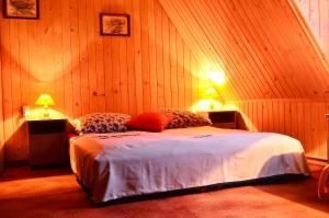 Un dormitorio con una cama con dos mesitas de noche y dos lámparas. en Chowańcówka, en Poronin