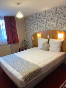 um quarto com uma cama grande num quarto em Logis - Hôtel et Restaurant Le Sofhotel em Forges-les-Eaux