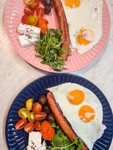 two plates of breakfast food with eggs and vegetables at Boho House in Pakoštane