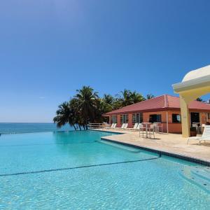 a large swimming pool next to a building at Parador Maunacaribe - Maunabo in Maunabo