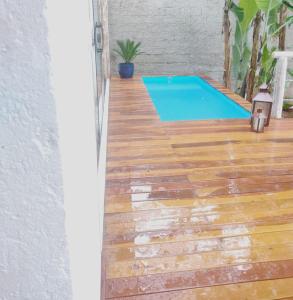 a swimming pool on a wooden floor with a swimming pool at Pousada Santa Vila in Serra do Cipo