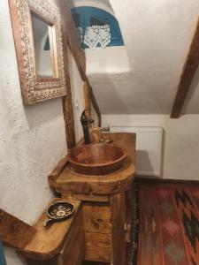 a bathroom with a wooden sink and a mirror at Casa Colț din Maramureș - Old Traditional House in Ocna Şugatag +64 photos