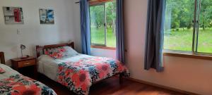 Postel nebo postele na pokoji v ubytování Cabañas Las Araucarias